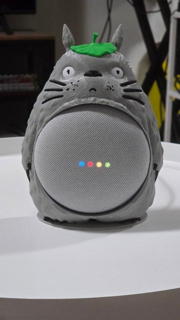 A 3D printed model of Totoro (from My Neighbor Totoro) in colour wearing a leaf hat and his belly is a Google Nest Mini speaker.