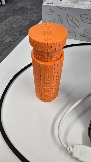 A 3D printed tower maze in orange colour saying 'Level 16' on top.