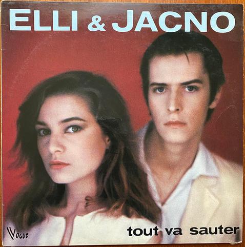 The album art is a very 80s photo of the artists, both looking at the camera and wearing cream coloured tops (Elli wears a sleevless top, Jacno a suit jacket with a white collared shirt underneath). There is a red background. The artists' names are in a large blue font at the top, and the album name is in smaller black font in the bottom right-hand corner.