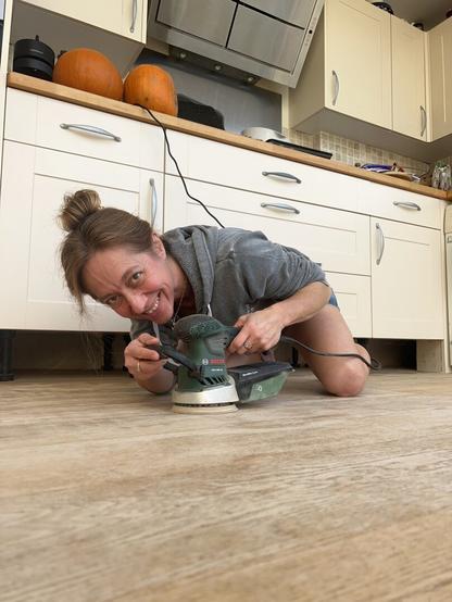 Me on the floor, sanding. it's a big floor. So far I'm smiling...