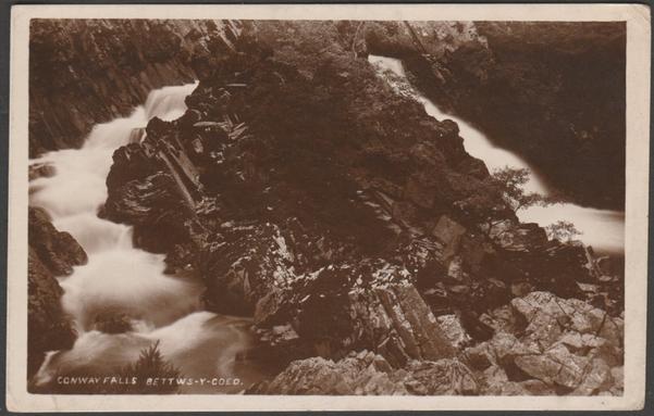 Sepia real photographic postcard showing a view of the Conwy Falls at Betws-y-Coed in Caernarvonshire.
Publisher not stated, not numbered, c.1930.
Postally unused.
Good condition, with slight corner bumps.