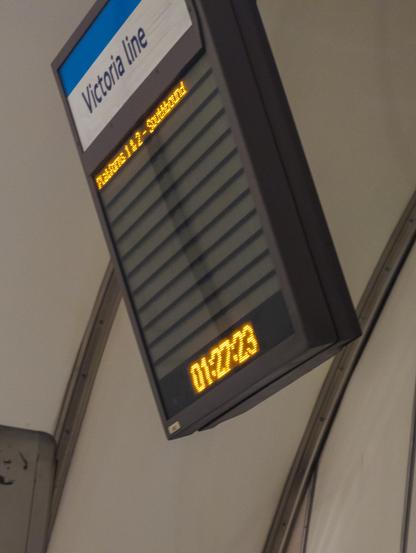London Underground station display board with the time '01:27:23' at the bottom, and above it 'Victoria Line' and 'Platforms 1&2 - Southbound'