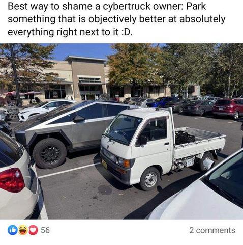 A kei truck (very small Japanese truck) parked next to a Tesla Cybertruck. The kei truck is about half the size
