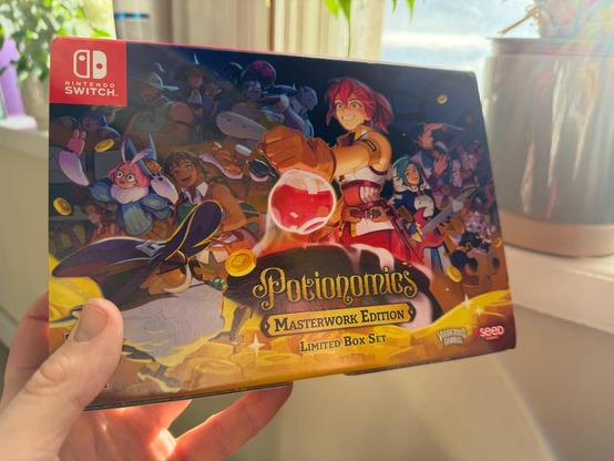 Image of me holding the Masterwork limited edition box for potionomics on the Nintendo switch