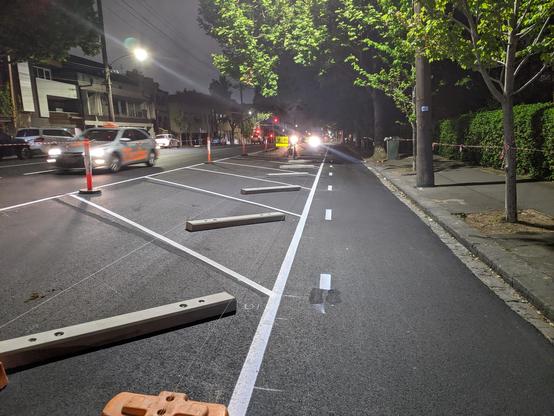 A photo of the protected bike lane with the angled parking bays