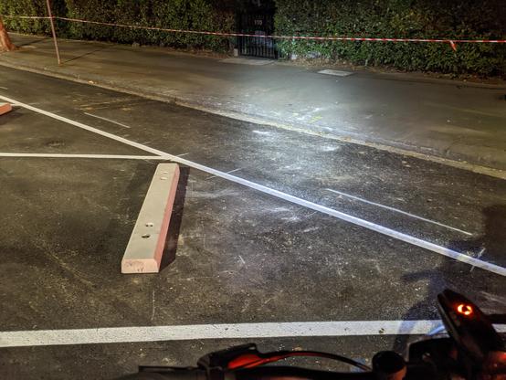 A side angle photo of the front of the parking bay show the distance between the chock and the bike lane