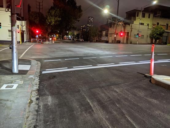 A photo of the bike lane heading easy at Cruzon at showing that the lane widens at the intersection and the relatively unprotected bike lane that continues easy on Arden.