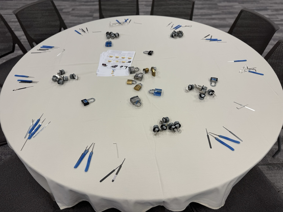 A round table with many lock picks and locks