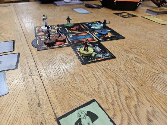 The house tiles from the game laid out in starting position with the figures.