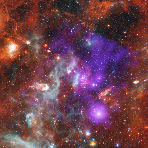 From source link in toot: This release features a composite image of the Cygnus OB2 star cluster, which resembles a night sky blanketed in orange, purple, and grey clouds.

The center of the square image is dominated by purple haze. This haze represents diffuse X-ray emissions, and young stars, detected by the Chandra X-ray observatory. Surrounding the purple haze is a mottled, streaky, brick orange cloud. Another cloud resembling a tendril of grey smoke stretches from our lower left to the center of the image. These clouds represent relatively cool dust and gas observed by the Spitzer Space Telescope.

Although the interwoven clouds cover most of the image, the thousands of stars within the cluster shine through. The lower-mass stars present as tiny specks of light. The massive stars gleam, some with long refraction spikes.