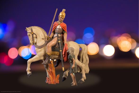 Das Bild zeigt eine Statue des Heiligen Martins in römischer Soldatenuniform auf einem Pferd, der einen Teil seines Mantels an einen Bettler gibt.