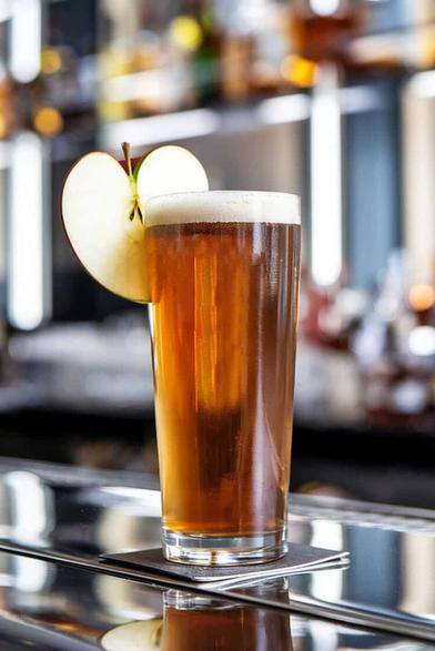 Diesel cocktail with apple garnish on bar