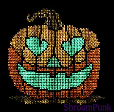 Lite brite art of a jack o lantern with a toothy grin.