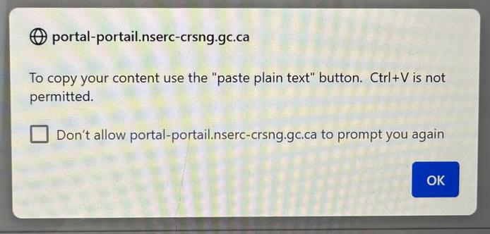 A photo of a screen showing a browser popup message refusing to allow copy paste into a text box. Instead you must use a special button.