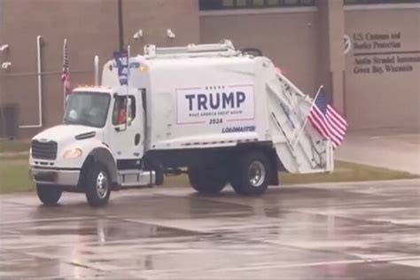 The white trump garbage truck on an airport runway