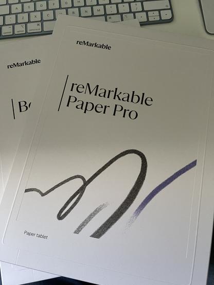 A Remarkable Paper Pro tablet box on my desk. The box is textured like paper are there are pencil swirls of different colours, weights, and textures printed on the cover.