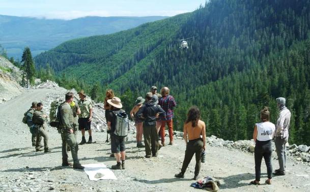 Activists with RCMP CIRG goons, on mountain logging road with RCMP helicopter coming in.