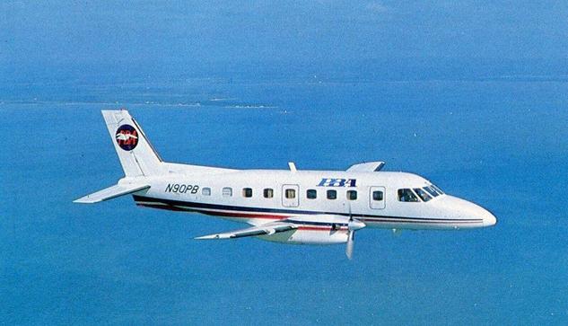 Prop Plane is flying left to right, over blue waters.