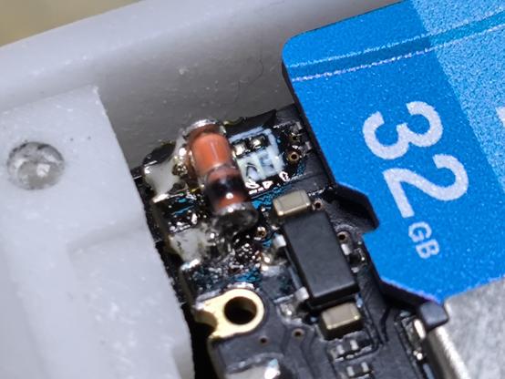 NanoKVM with the heatsink and cover removed showing the PCB with a cylindrical glass diode soldered between two pins.