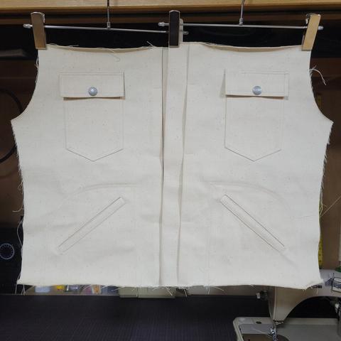 The front panels of a white sateen jacket under construction