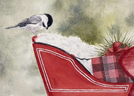 Chickadee perched on the back of a Christmas sleigh
