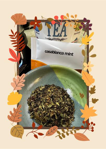 A small pottery bowl contains a mix of peppermint leaves and black teas. A package labeled Casablanca Mint from Adagio Tea is propped between the bowl and a tea mug that has the word Tea on it.  The photo has an autumnal border of various fall leaves.