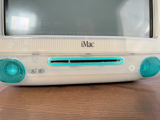 An iMac G3 slot loader with replaced front optical drive bezel