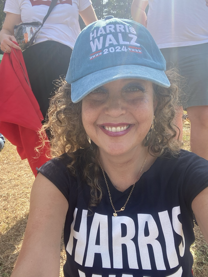 A photo of me at the Harris!!! rally in Georgia with a blue baseball cap and Harris Walz T-shirts