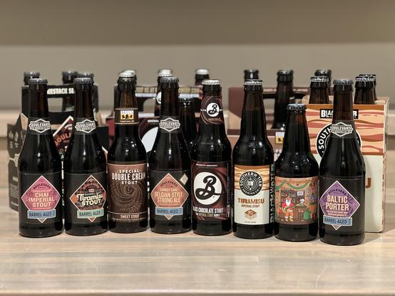 Many beers from Boulevard_Beer #prairieAles #BellsBrewery #brooklynbrewery #southernTierBrewing 

8 bottles in the foreground with assorted 4 and 6 pack carriers behind