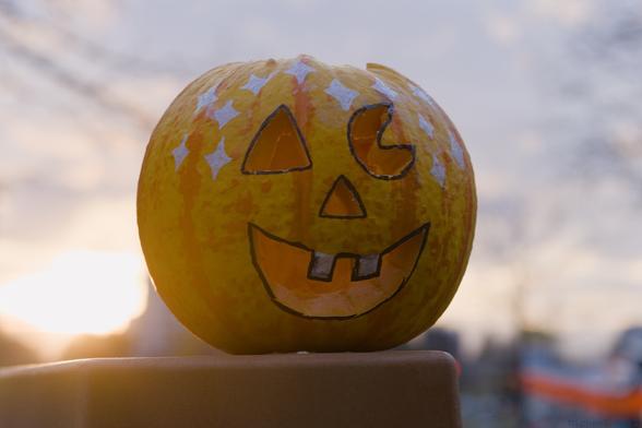 A cheerful jackolantern in front of an unseasonably warm October 31st sunset.