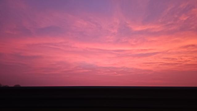 Tramonti di porpora...

The image shows a beautiful sunset or with a sky filled with vibrant pink and purple hues. The horizon is dark, suggesting an outline of land or a silhouette of trees beneath the colorful sky.