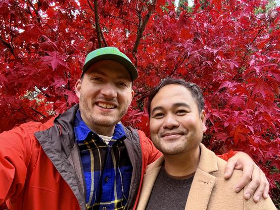 Selfie with my boyfriend in front of a brick red Japanese maple tree