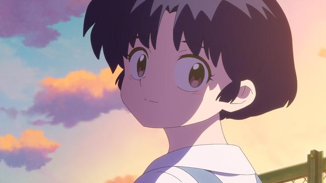 A close-up shot of Akane Tendo, a female anime character with large brown eyes and short black hair, shown from a side angle. She is wearing a white collar or shirt. The background features a sunset sky with purple and orange clouds. The art style is soft and the lighting gives the scene a warm, dreamy atmosphere.