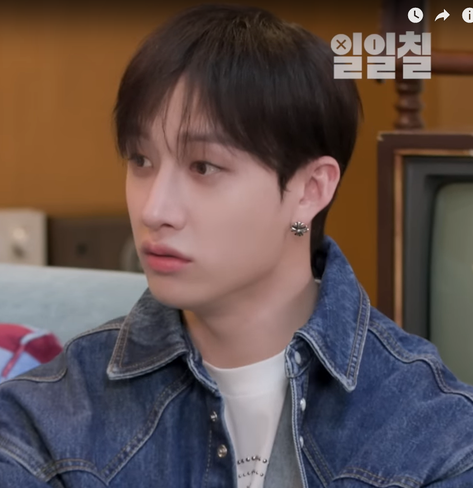 Bang Chan wearing the round flower cross earrings