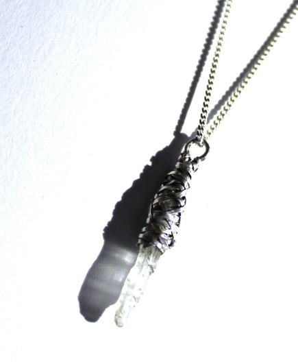 woven selenite pendant on white background
