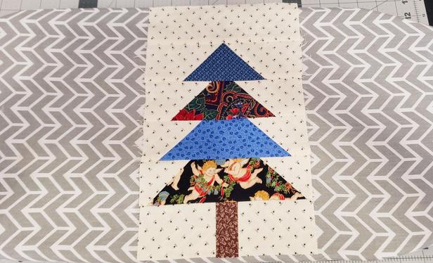 A patchwork Christmas tree block made with my grandmother's scrap fabric.