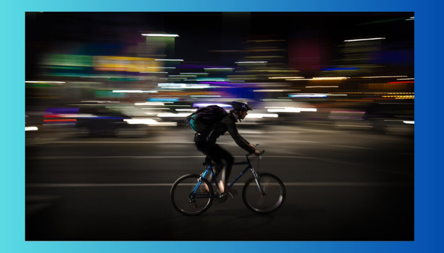 bicyclist riding at night in the city