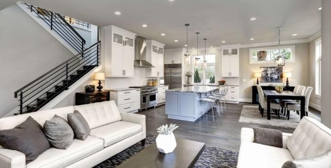 living room with open kitchen, with ceiling led lights and table lamps