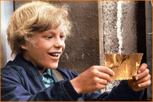 A boy holding a golden ticket