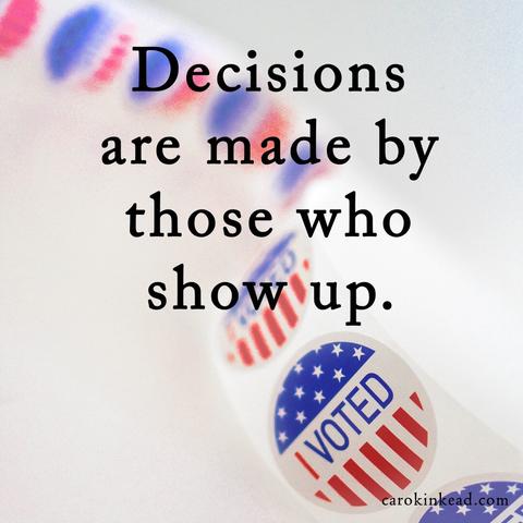 On a white background, a strip of "I Voted" stickers. Over this are the words, "Decisions are made by those who show up," usually attributed to Aaron Sorkin for The West Wing, though he says he heard it elsewhere.