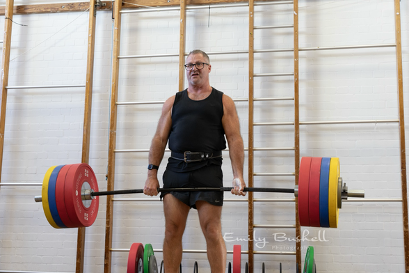 Older man picks up heavy weights