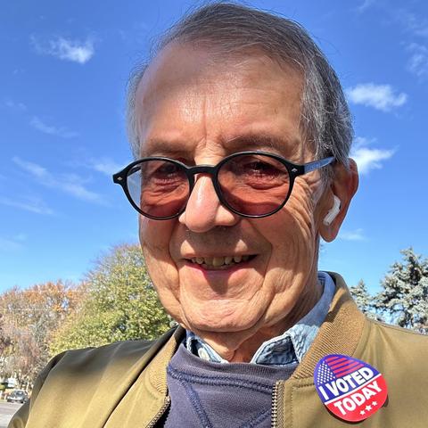 Color outdoor photo of older man (me!) wearing an ‘I Voted Today’ sticker. The sky behind him is brilliant blue with a few small scattered clouds. Harrisburg PA