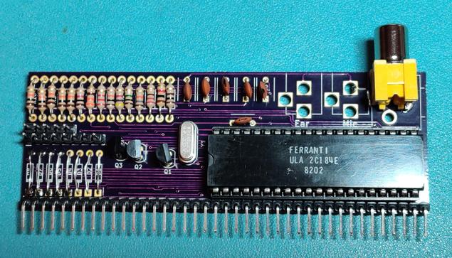 purple PCB full of resistors, capacitors and a big black chip.
