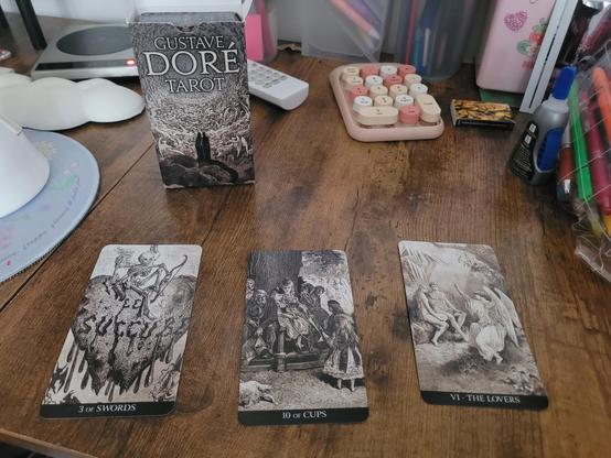 The 3-card spread from my Gustave Doré tarot on my desk. The tarot deck cover is the famous illustration of Danté and Virgil standing before the infinite rings of hell. Feels like us tbh