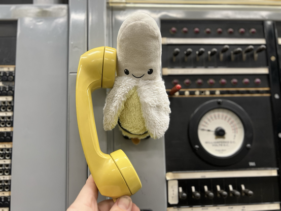 A small stuffed banana answering the phone