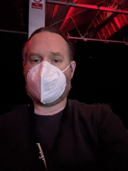 Selfie in a dark room with mask on