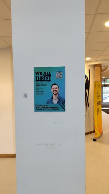 A photo of a We All Thrive with Unreal Music event flyer on a pillar in SETU