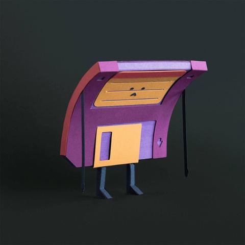 A whimsical, colorful paper craft floppy disk character with a rectangular purple and orange head, small eyes, and thin black legs against a dark background.