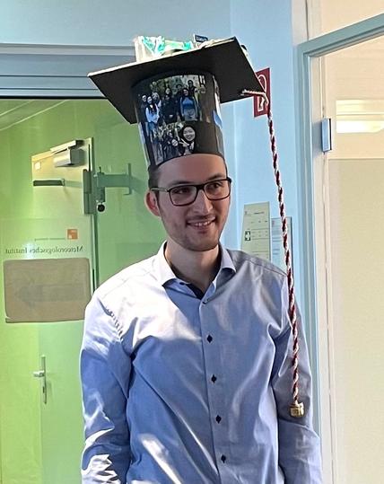 Florian Römer with a custom-made PhD hat after his disputation.