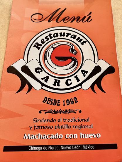 A menu cover for "Restaurant Garcia," featuring its logo and the phrase "Desde 1952." It mentions serving a traditional regional dish called "Machacado con huevo," and indicates the location as Ciénega de Flores, Nuevo León, México.